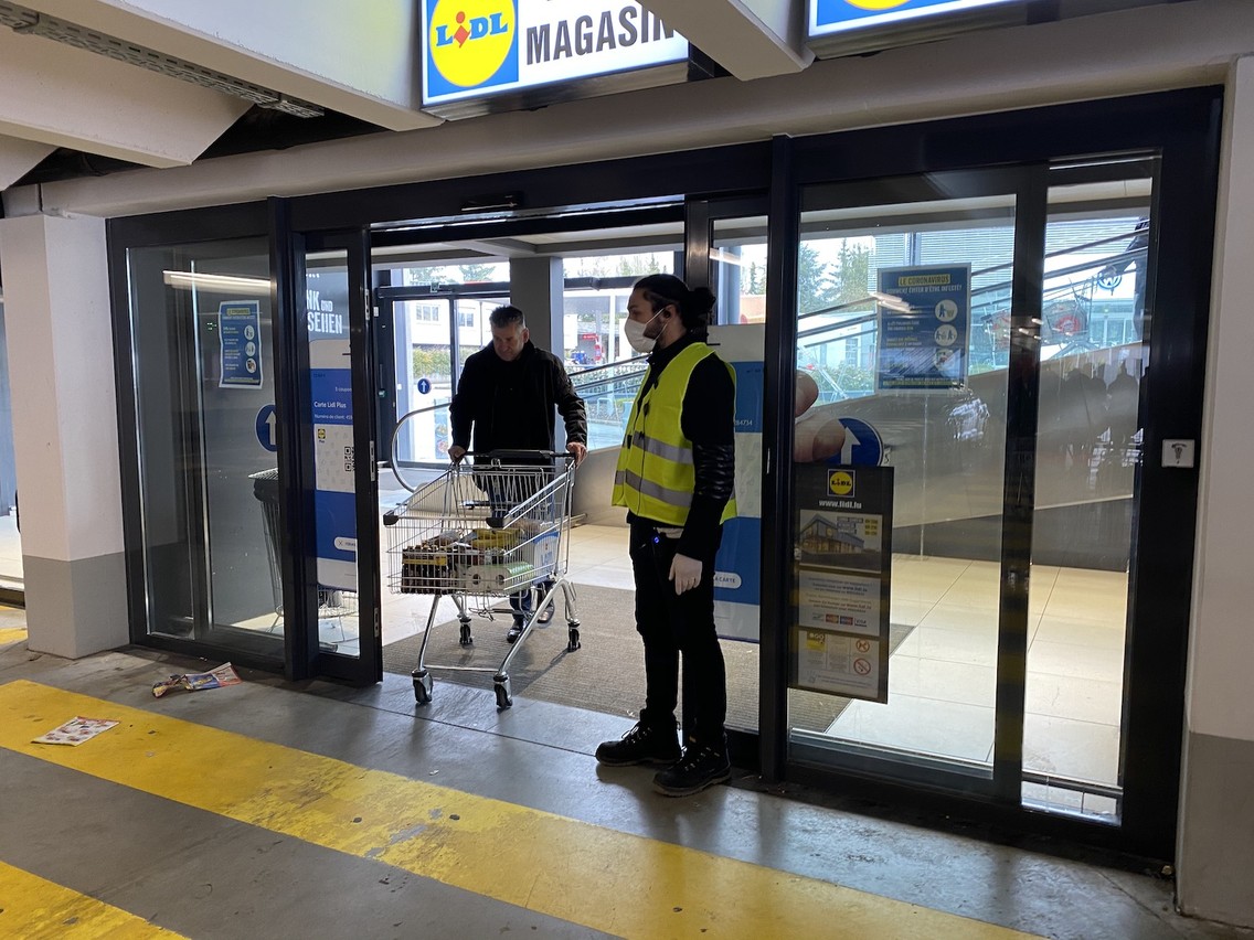 Chez Lidl, l’entrée se fait par une porte unique, en bas, avec un vigile qui filtre le nombre de clients et qui oblige à prendre un chariot pour s’assurer que tout le monde conserve une distance de sécurité. (Photo: Paperjam)